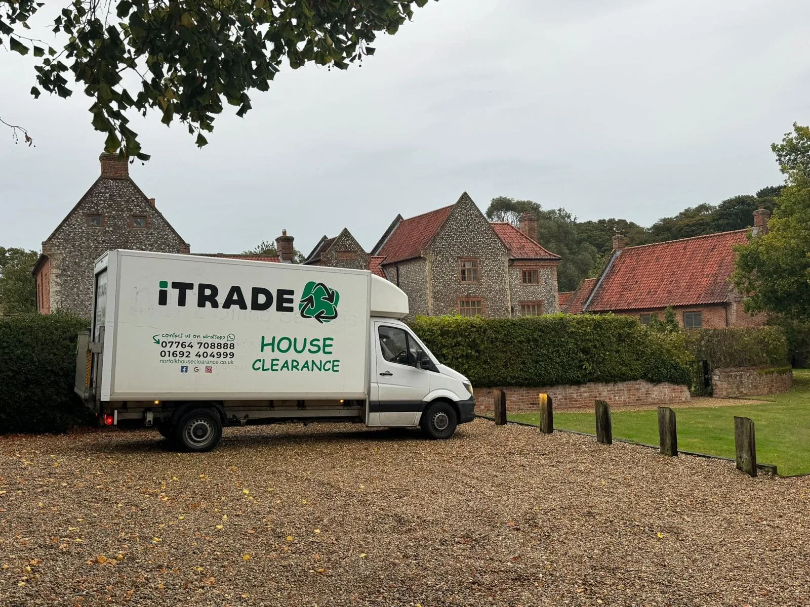 iTrade house-clearance vehicle outside a large flint and brick property